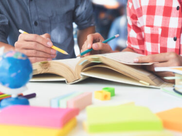 Young students campus helps friend catching up and learning.